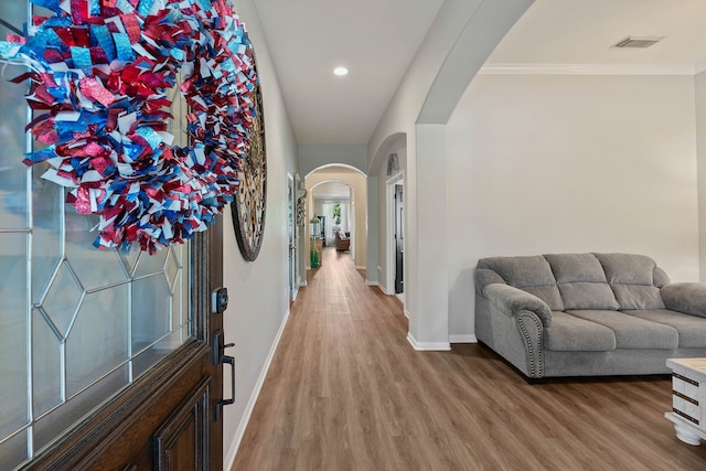2504 N Yorkchase Ln, Conroe, TX 77304 - foyer entrance featuring arched walkways, baseboards, wood finished floors, recessed lighting, and ornamental molding