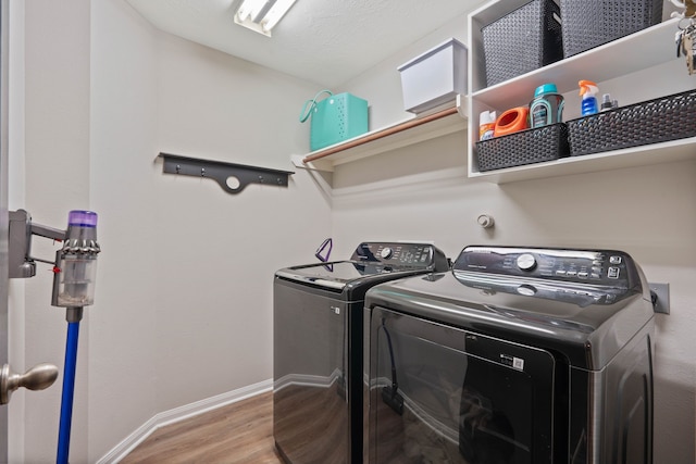 2504 N Yorkchase Ln, Conroe, TX 77304 - laundry area featuring washing machine and dryer, wood finished floors, and baseboards