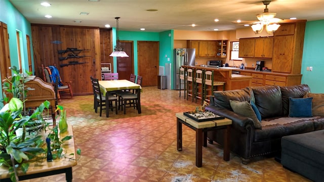 2301 Hines Lake Rd, Coldspring, TX 77331 - living room with light flooring, recessed lighting, a ceiling fan, and wooden walls