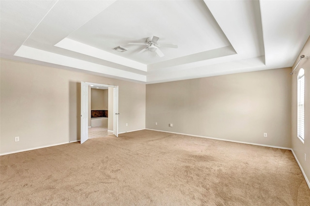 461 Mystic Glen Loop, Houston, TX 77339 - unfurnished room featuring a tray ceiling, ceiling fan, light carpet, and baseboards