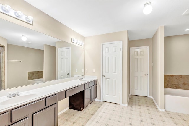 461 Mystic Glen Loop, Houston, TX 77339 - bathroom featuring a garden tub, double vanity, tile patterned floors, and baseboards