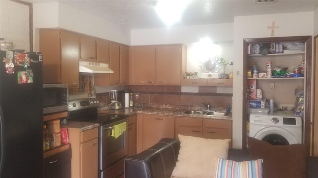 7267 Cook Rd, Houston, TX 77072 - kitchen with appliances with stainless steel finishes, under cabinet range hood, a sink, washer / clothes dryer, and tasteful backsplash