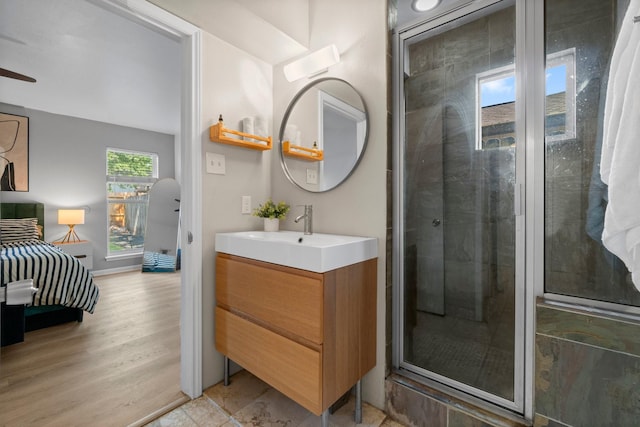 1919 Shadowdale Dr, Houston, TX 77043 - bathroom with vanity, a stall shower, and wood finished floors