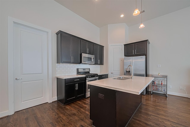 72 N Hutcheson St, Houston, TX 77003 - kitchen with stainless steel appliances, a sink, light countertops, dark wood-type flooring, and tasteful backsplash