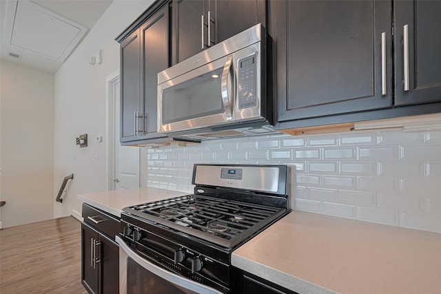 72 N Hutcheson St, Houston, TX 77003 - kitchen featuring appliances with stainless steel finishes, backsplash, light countertops, and light wood-style floors