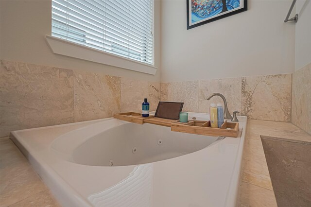72 N Hutcheson St, Houston, TX 77003 - bathroom featuring a tub with jets and wainscoting