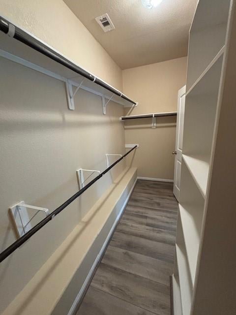 995 Arbor Gln, Conroe, TX 77303 - walk in closet with dark wood finished floors