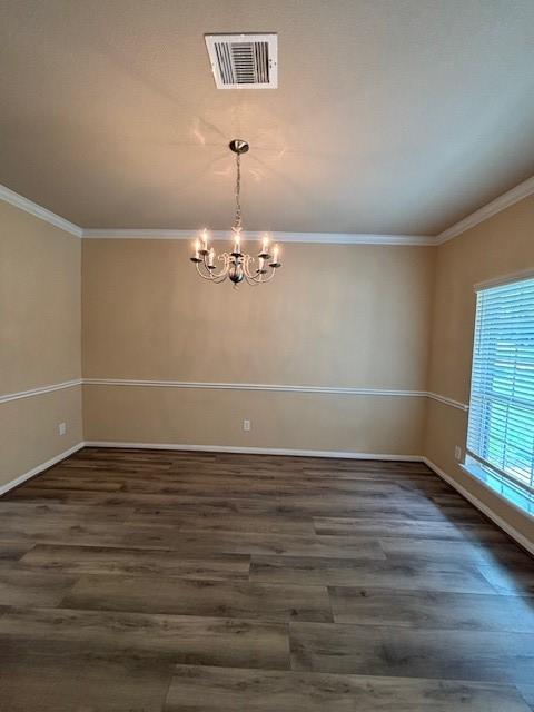 995 Arbor Gln, Conroe, TX 77303 - spare room with wood finished floors, a chandelier, crown molding, and baseboards