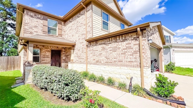 706 Hardwood Grove Ct, Houston, TX 77090 - view of front of home featuring an attached garage, brick siding, and driveway