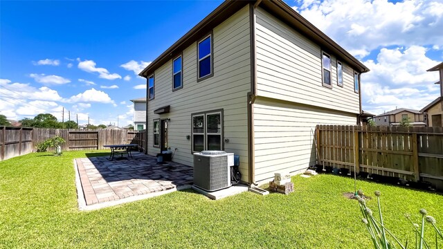 706 Hardwood Grove Ct, Houston, TX 77090 - back of property featuring central air condition unit and a patio