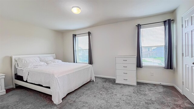 706 Hardwood Grove Ct, Houston, TX 77090 - bedroom featuring multiple windows, carpet flooring, and baseboards