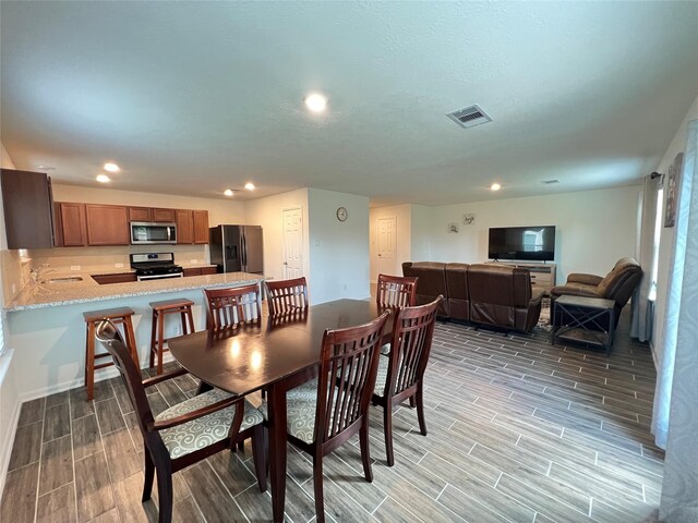 706 Hardwood Grove Ct, Houston, TX 77090 - dining room featuring wood finish floors and recessed lighting