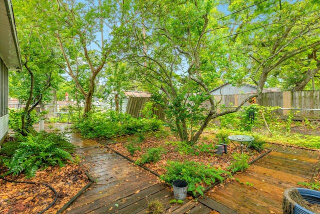 204 Caladium St, Lake Jackson, TX 77566 - fenced backyard with a deck and cooling unit