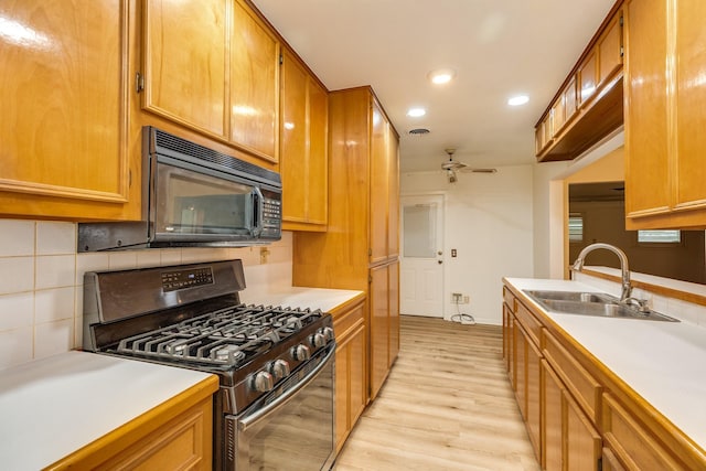 204 Caladium St, Lake Jackson, TX 77566 - kitchen with gas range oven, black microwave, a sink, recessed lighting, and light wood finished floors