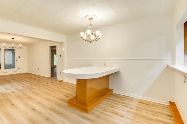 204 Caladium St, Lake Jackson, TX 77566 - unfurnished dining area featuring a chandelier, light wood-style floors, crown molding, and baseboards