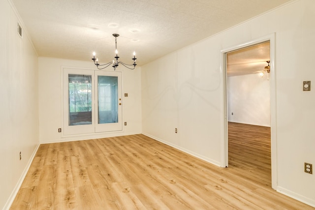 204 Caladium St, Lake Jackson, TX 77566 - spare room featuring a chandelier, light wood-style floors, ornamental molding, and baseboards