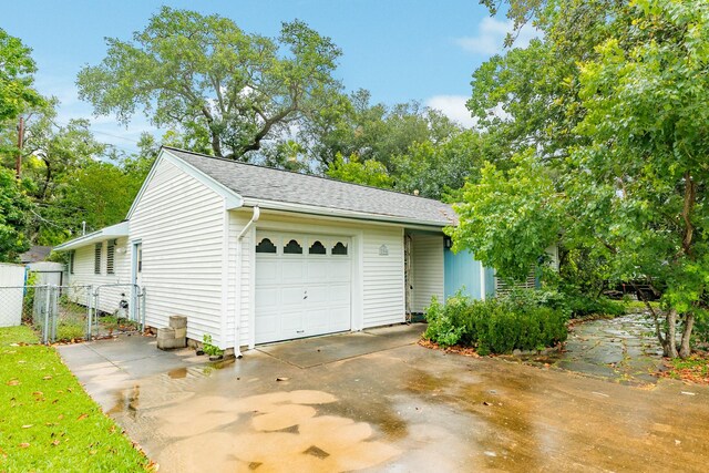 204 Caladium St, Lake Jackson, TX 77566 - garage featuring concrete driveway and a gate