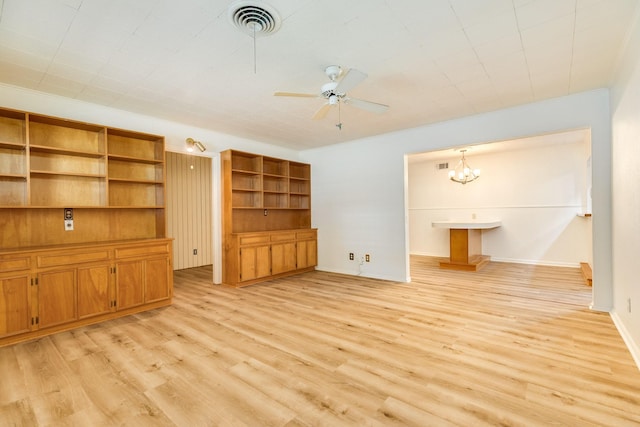 204 Caladium St, Lake Jackson, TX 77566 - unfurnished living room with light wood-style flooring, ceiling fan, and a chandelier
