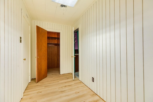 204 Caladium St, Lake Jackson, TX 77566 - corridor with light wood-style flooring and wood walls