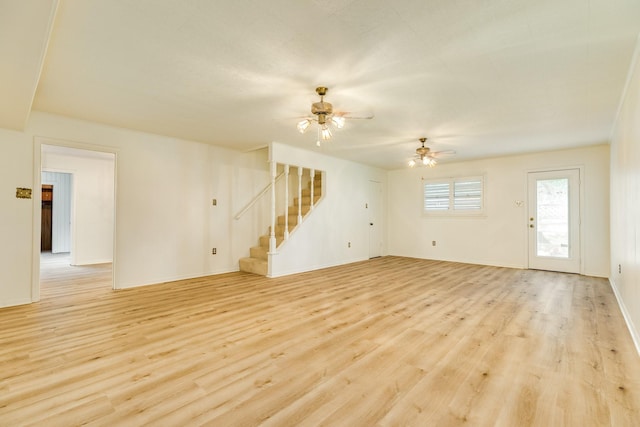 204 Caladium St, Lake Jackson, TX 77566 - unfurnished living room featuring stairs, a ceiling fan, light wood-style floors, and baseboards