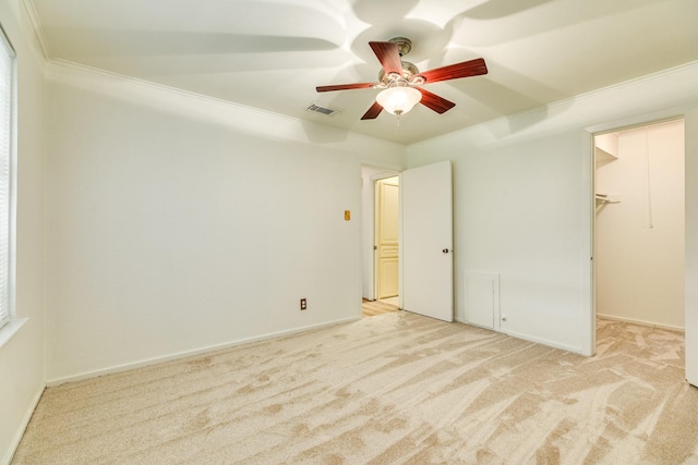 204 Caladium St, Lake Jackson, TX 77566 - unfurnished bedroom featuring carpet floors, crown molding, a spacious closet, a ceiling fan, and baseboards