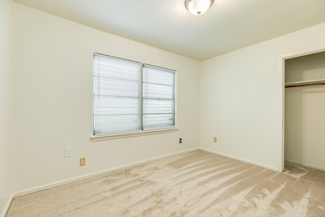 204 Caladium St, Lake Jackson, TX 77566 - unfurnished bedroom featuring light colored carpet, a closet, and baseboards