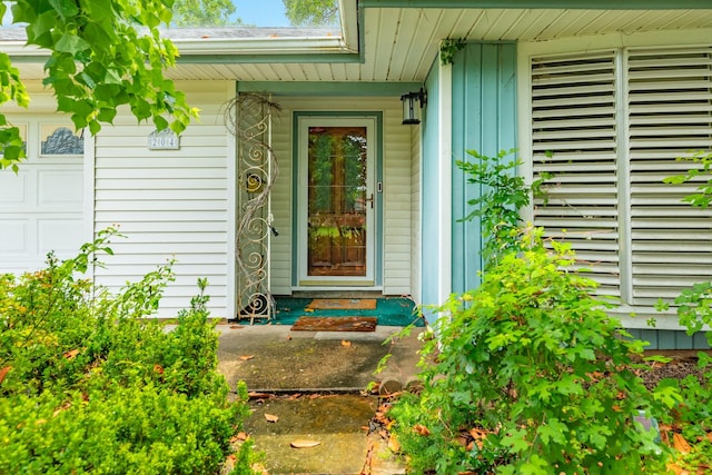 204 Caladium St, Lake Jackson, TX 77566 - entrance to property featuring a porch, board and batten siding, and an attached garage
