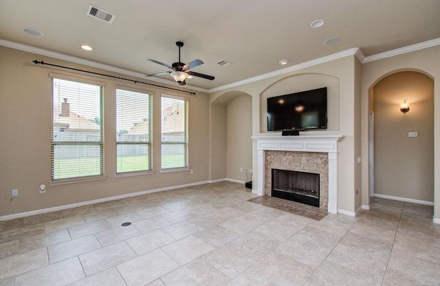 9126 Lake Lewisville Ct, Cypress, TX 77433 - unfurnished living room with ceiling fan, arched walkways, ornamental molding, a tiled fireplace, and baseboards