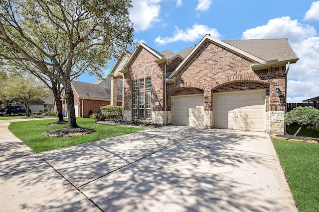 4214 Bridgestone Shadow Ct, Spring, TX 77388 - view of front of property with concrete driveway, brick siding, a front lawn, and stone siding