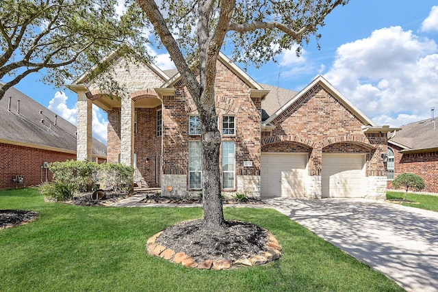 4214 Bridgestone Shadow Ct, Spring, TX 77388 - view of front of home with driveway, brick siding, a front yard, an attached garage, and stone siding