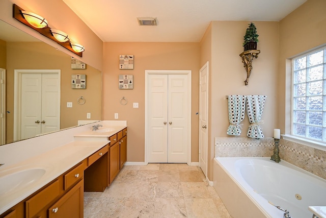 4214 Bridgestone Shadow Ct, Spring, TX 77388 - full bathroom featuring a closet, double vanity, a tub with jets, and baseboards