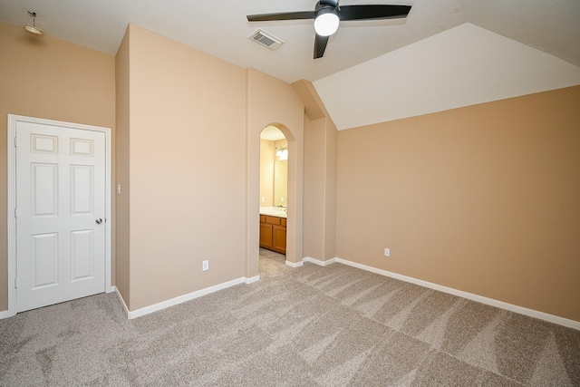 4214 Bridgestone Shadow Ct, Spring, TX 77388 - unfurnished bedroom featuring light carpet, arched walkways, baseboards, vaulted ceiling, and ensuite bath