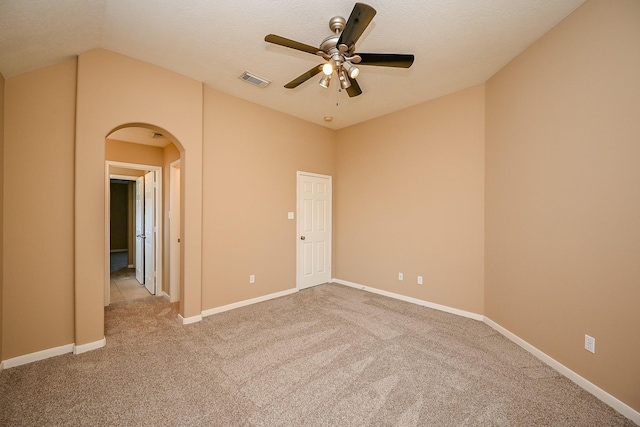 4214 Bridgestone Shadow Ct, Spring, TX 77388 - empty room featuring arched walkways, carpet flooring, a ceiling fan, baseboards, and lofted ceiling