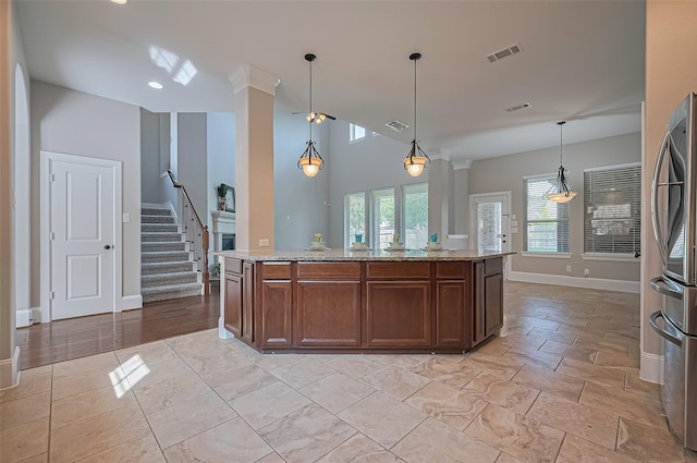10002 Hutton Park Dr, Katy, TX 77494 - kitchen with freestanding refrigerator, baseboards, light stone counters, decorative light fixtures, and recessed lighting