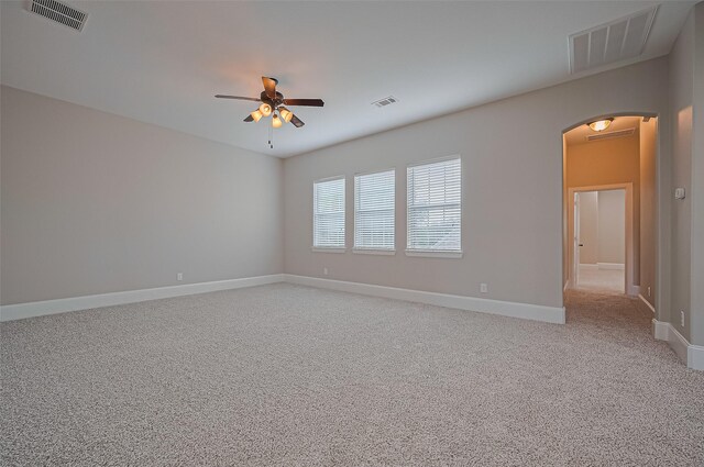 10002 Hutton Park Dr, Katy, TX 77494 - empty room with arched walkways, a ceiling fan, light carpet, and baseboards
