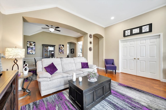 2206 E Van Trease Dr, Deer Park, TX 77536 - living area featuring arched walkways, wood finished floors, a ceiling fan, lofted ceiling, and ornamental molding