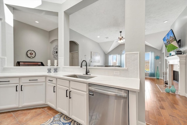 2206 E Van Trease Dr, Deer Park, TX 77536 - kitchen featuring stainless steel dishwasher, a sink, a ceiling fan, light countertops, and vaulted ceiling