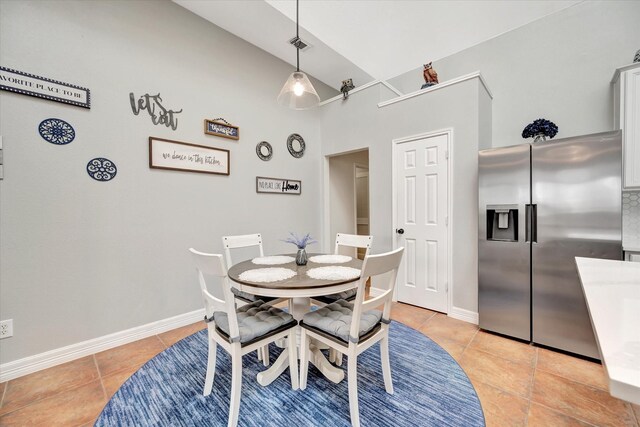 2206 E Van Trease Dr, Deer Park, TX 77536 - dining area featuring light tile patterned floors, high vaulted ceiling, and baseboards