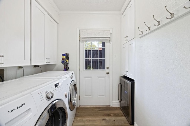 12302 Overcup Dr, Houston, TX 77024 - laundry room with cabinet space, washer and clothes dryer, wood finished floors, and crown molding