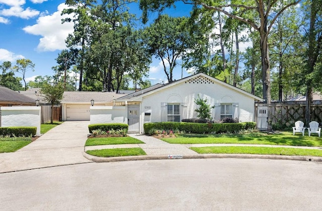 12302 Overcup Dr, Houston, TX 77024 - view of front of home with driveway, a garage, and a gate