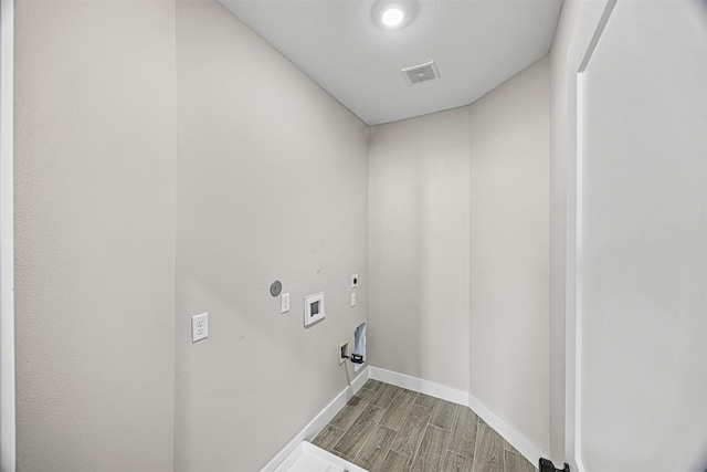 8128 Chateau St, Houston, TX 77028 - washroom featuring hookup for an electric dryer, wood finished floors, washer hookup, and baseboards