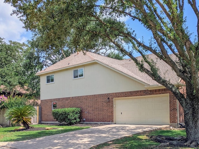 2710 Magnolia Walk, Spring, TX 77388 - view of home's exterior featuring brick siding, driveway, a garage, and a shingled roof
