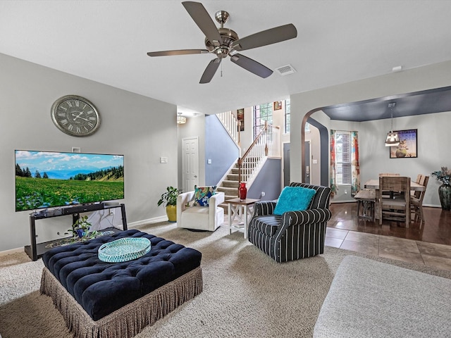 2710 Magnolia Walk, Spring, TX 77388 - living room featuring stairway, a ceiling fan, baseboards, arched walkways, and tile patterned floors