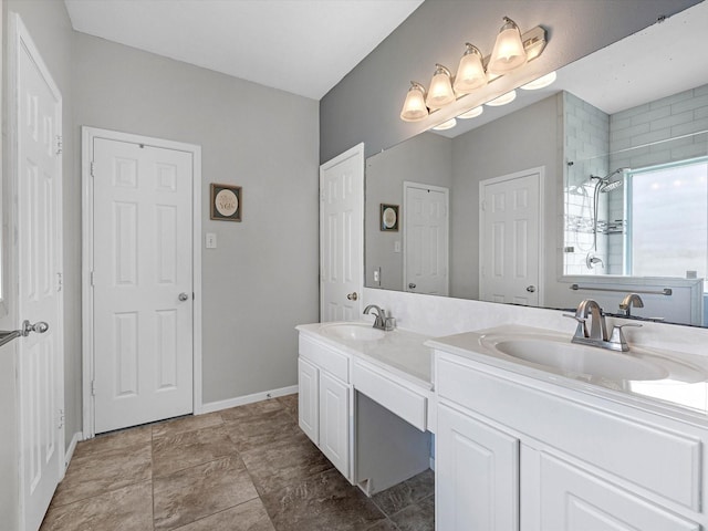 2710 Magnolia Walk, Spring, TX 77388 - bathroom with double vanity, tiled shower, and baseboards
