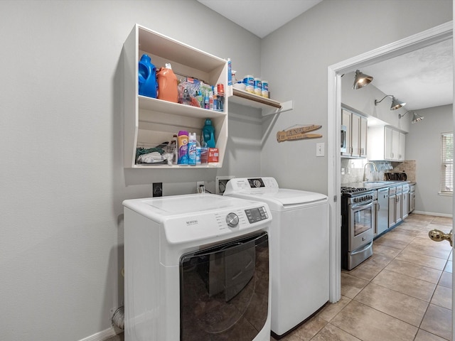 2710 Magnolia Walk, Spring, TX 77388 - laundry room featuring washer and clothes dryer and light tile patterned floors