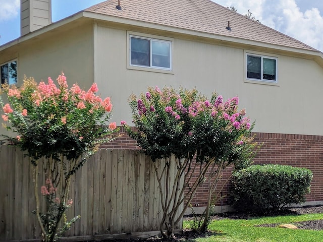2710 Magnolia Walk, Spring, TX 77388 - view of side of home featuring a chimney, brick siding, and roof with shingles