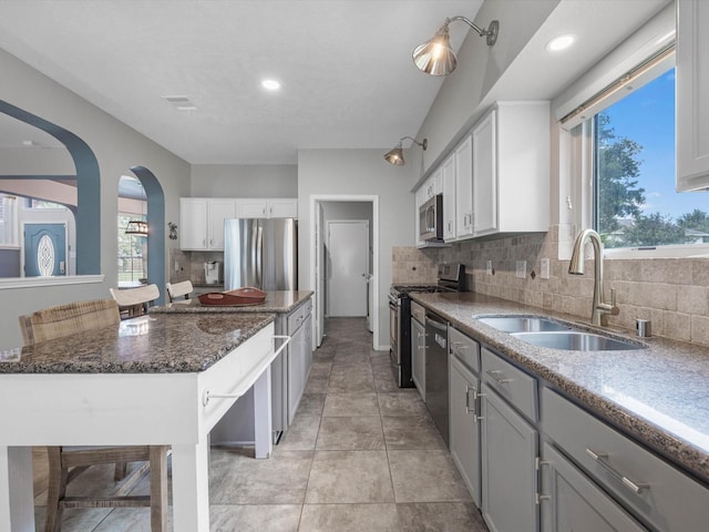 2710 Magnolia Walk, Spring, TX 77388 - kitchen with stainless steel appliances, a sink, backsplash, dark stone countertops, and recessed lighting