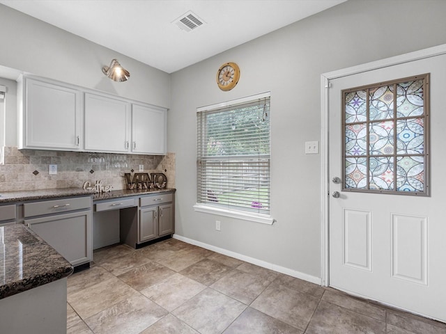 2710 Magnolia Walk, Spring, TX 77388 - kitchen featuring decorative backsplash, dark stone counters, baseboards, gray cabinetry, and white cabinetry