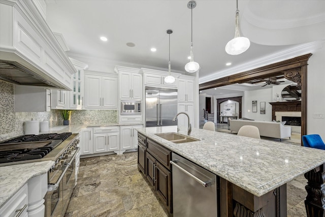 10 Broadwater Ct, Shenandoah, TX 77381 - kitchen with built in appliances, a sink, custom exhaust hood, tasteful backsplash, and a ceiling fan