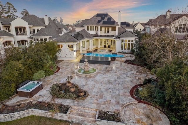 10 Broadwater Ct, Shenandoah, TX 77381 - back of house featuring an outdoor hot tub, a patio area, solar panels, a residential view, and an outdoor pool